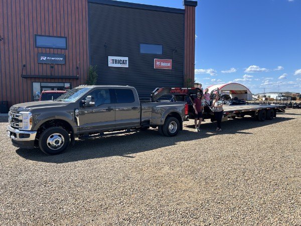 Tim Coy and his family with the Talico Ventures truck and 30-foot gooseneck trailer