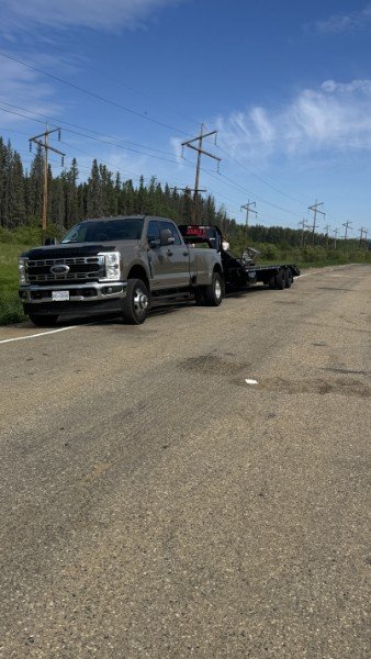 Talico Ventures truck and gooseneck trailer heading north on the highway